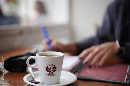 woman working with cup of coffee