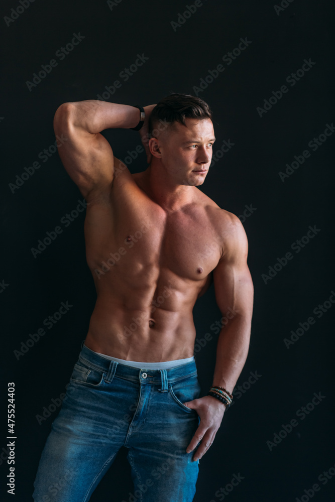 young man, brutal appearance, with a beautiful torso, bodybuilder, in the studio