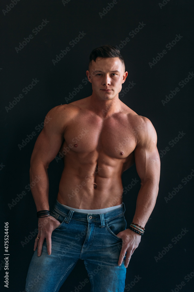Fototapeta premium young man, brutal appearance, with a beautiful torso, bodybuilder, in the studio
