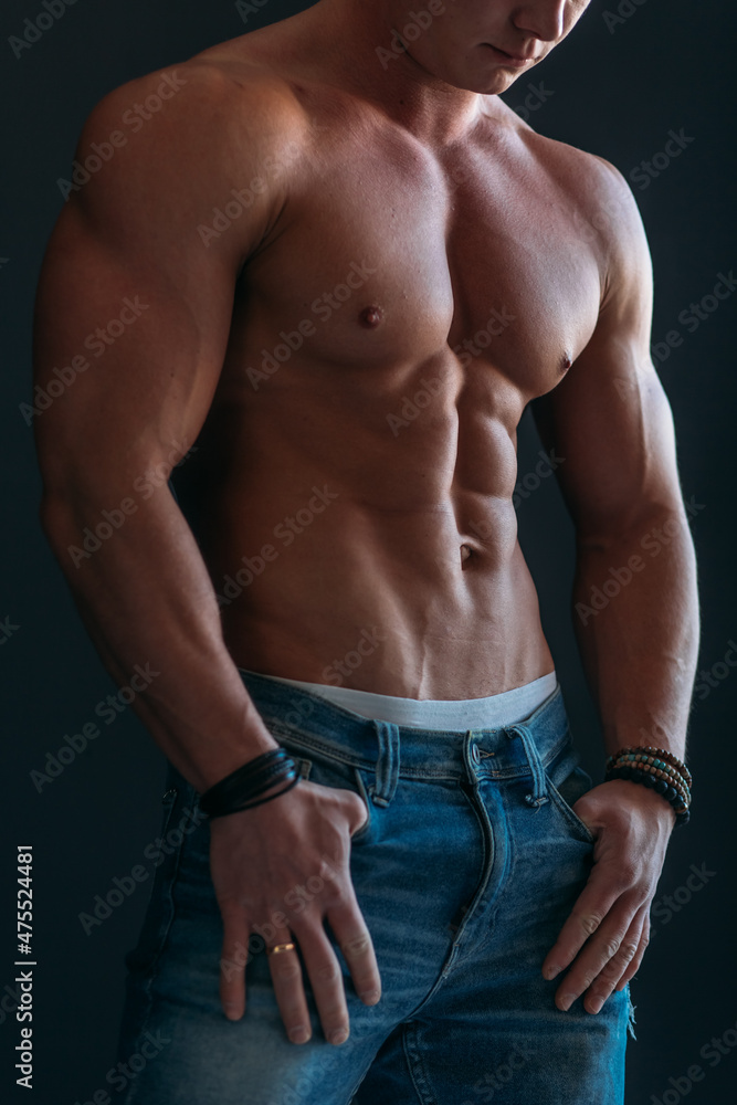 young man, brutal appearance, with a beautiful torso, bodybuilder, in the studio