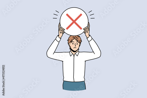 Stop and reject sign concept. Young frustrated serious man worker standing holding round red rejecting denying stop sign in hands vector illustration 