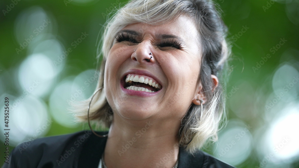 Young woman authentic laugh and smile outside Young woman authentic laugh and smile outside