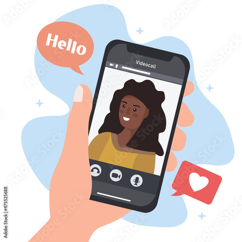 A hand with a smartphone and a person on the screen. Communicating in social networks and messengers via video call. Mobile applications and Internet technology. flat vector