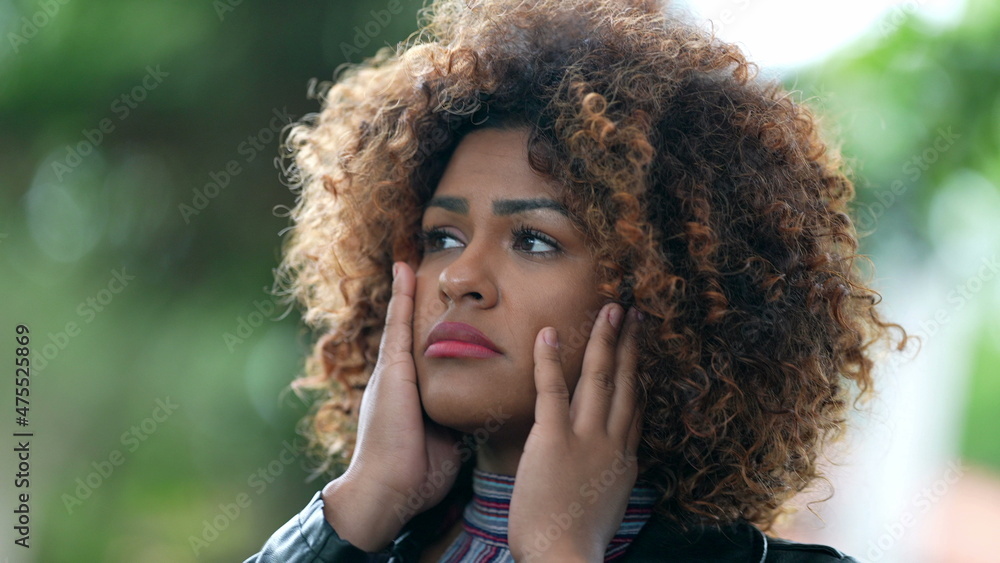 Worried black hispanic woman feeling regret despair Worried black hispanic woman feeling regret despair