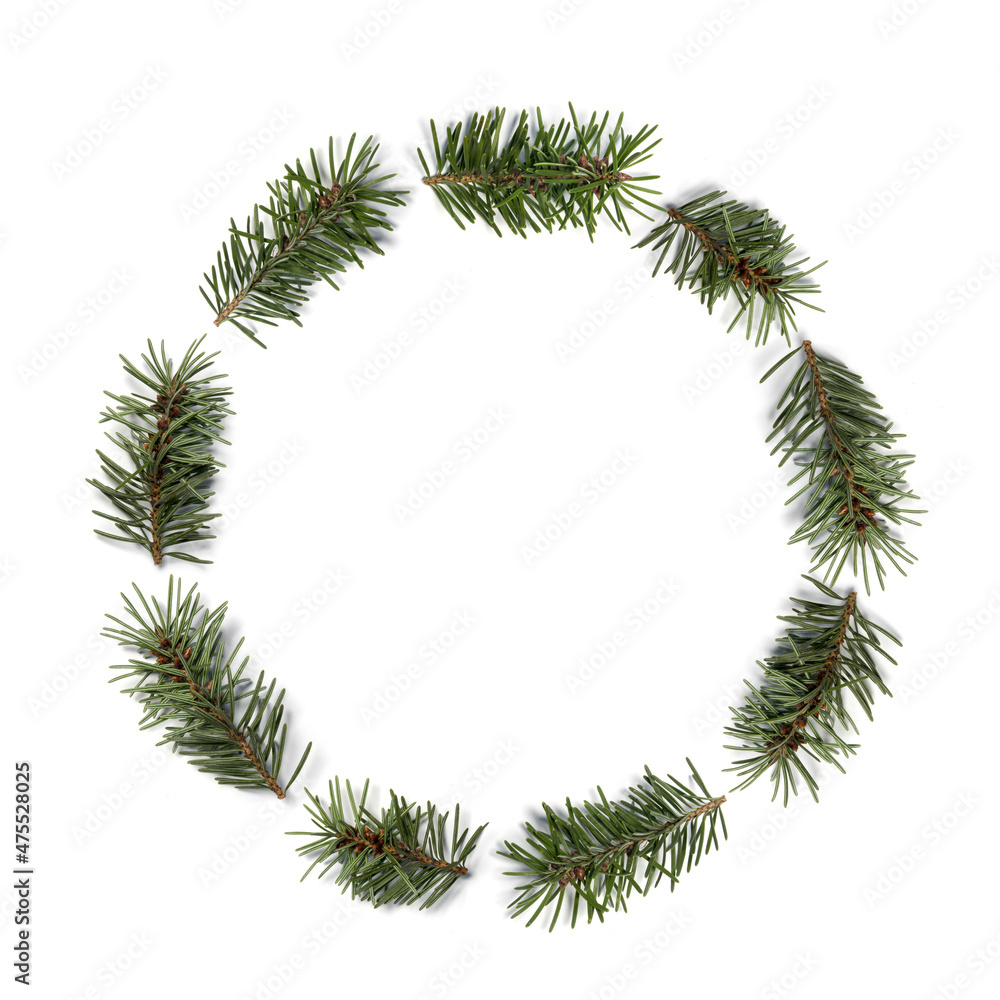 Simple Christmas Decoration Made of Green Pine Twigs Arranged in a Round Wreath on a White Background.Modern Christmas Decoration without Text ideal for Card, Greetings,Banner. Winter Holidays Decor. 