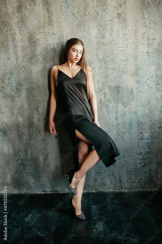 Portrait of brunette girl in a black dress. Portrait of brunette girl in a black dress.