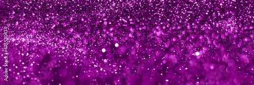 Velvet violet sparkling glitter background, christmas texture. Holiday lights. Abstract defocused header. Wide screen wallpaper. Panoramic web banner with copy space for design