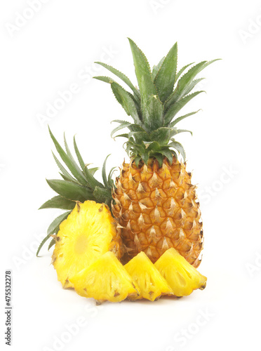 Whole fresh ripe pineapple fruit and pineapple fruit slices isolated on white background. 