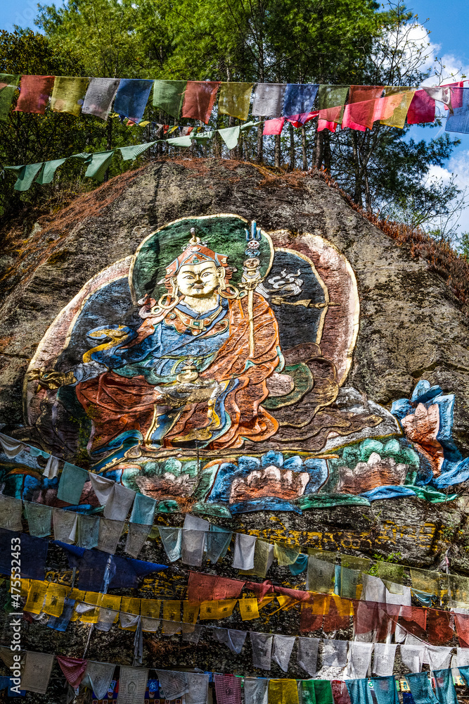 Colorful image of Guru Rinpoche op a rock near Tango Goemba monastery in Bhutan, Asia