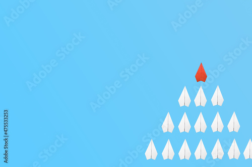 red paper plane leading among a white planes on blue background. Business competition and Leadership concept
