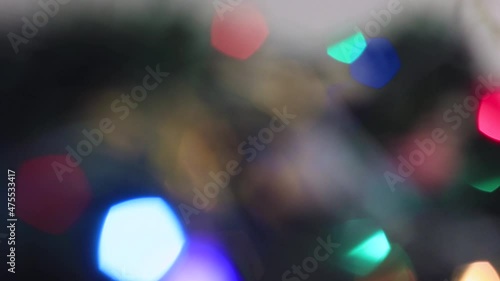 Blurred Christmas mystical multicolored lights are burning brightly. New Year's light out of focus. Video, footage for screensaver, intro, presentation, transition, congratulations, effects. UHD 4K. photo