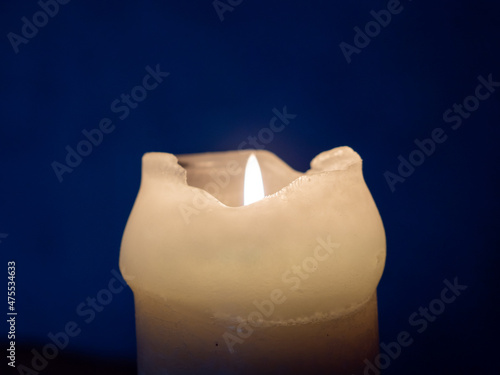 Burning candle in the dark close-up.