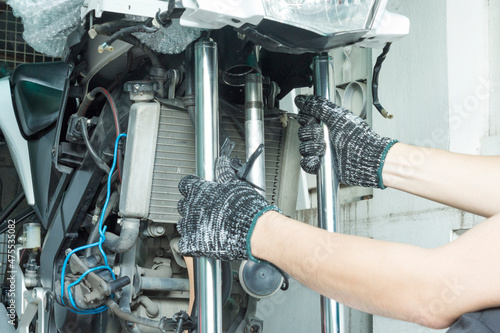 Auto mechanic disassembly motorcycle steering stem, Motorcycle maintenance service.