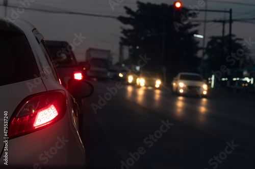 Cars on the road in traffic junction at night with red light signal. There are many car on the road.