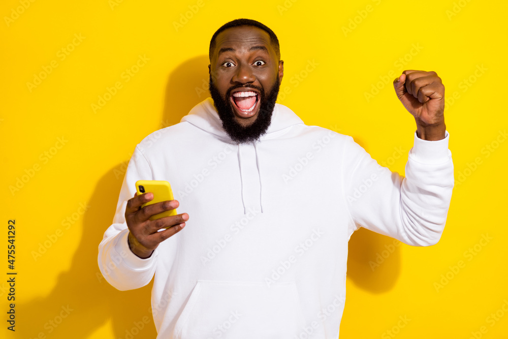 Photo of hooray millennial beard man hold telephone yell wear white sportscloth isolated on yellow color background Photo of hooray millennial beard man hold telephone yell wear white sportscloth isolated on yellow color background