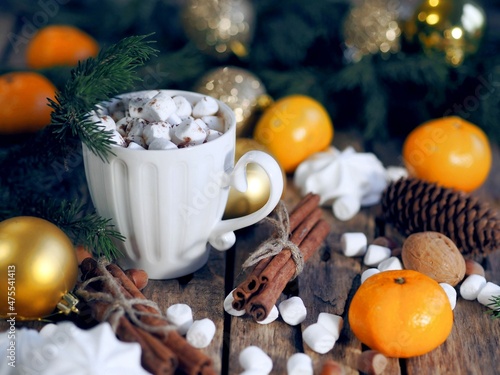 New Year is still life with a retro alarm clock  fir branches  candles and natural decorations on a wooden background. Merry Christmas and Happy New Year.