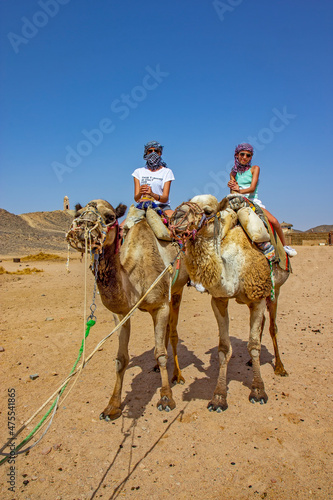 Girls riding camel in the Egyptian desert