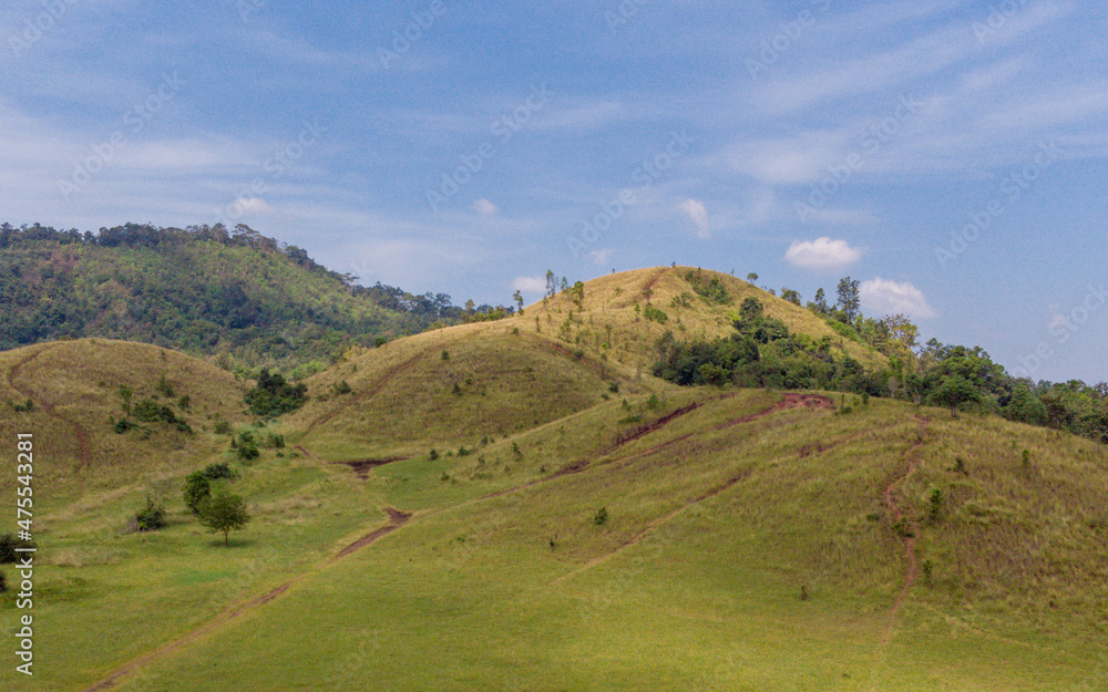 bald mountain or Phu Khao Ya with green grass field and blue sky. One of natural travel attraction in Ranong province, Thailand