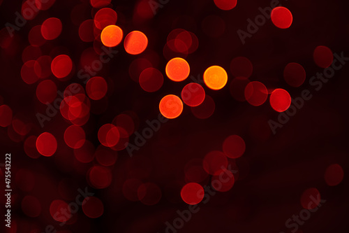 Red lights abstract background. Colorful defocused lights. Blurred glowing lights on dark background.