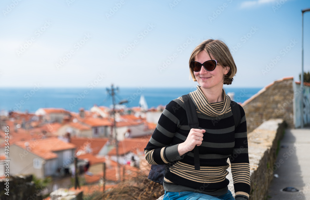 Fototapeta premium Holiday portrait of a smiling 30 year old white woman at the seaside, Piran, Slovenia