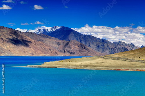 Blue water of Pangong tso (Lake). It is huge lake in Ladakh, shared by China and India along India China LOC border, Himalayan mountains alonside from India to Tibet.  Ladakh, Jammu and Kashmir, India © mitrarudra