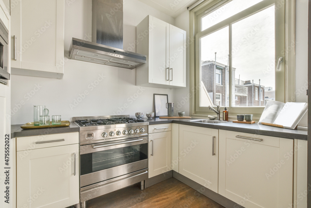 Interior of spacious kitchen placed near window Interior of spacious kitchen placed near window