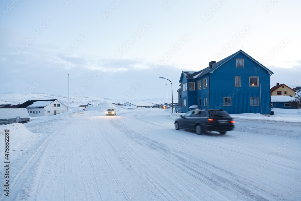 Cars driving in a snowy town