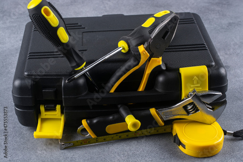 Repair tools and black plastic case close-up.