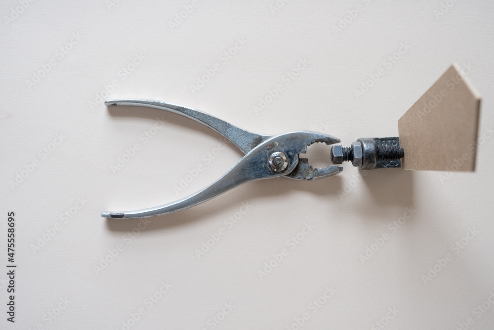 Obraz premium pliers with metal object and wood