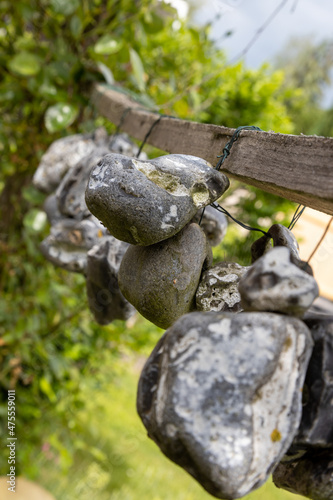 Stones or chicken gods hanging on a rope in the open air