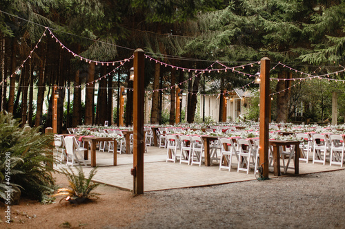 Wallpaper Mural Wedding arch in the woods with light bulbs Beautiful  rustic wedding in the forest String Lights Elements of the wedding decor Light bulb decor in the Wedding party wedding tables, chairs background Torontodigital.ca