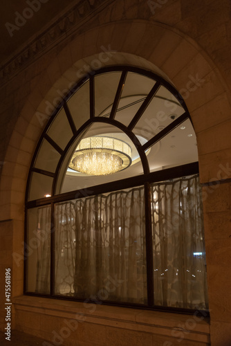 Beautiful chandelier as seen through an arched window at a luxury hotel in Jerusalem  Israel 