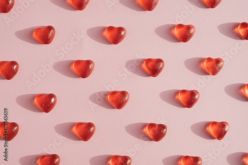 Heart shaped gummy candy pattern against light pink background. Romantic minimal concept