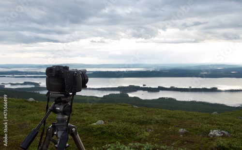 camera on tripod shooting landscape above Arjeplog