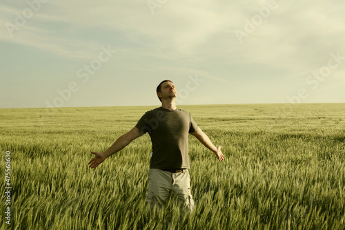 Man and field, sky landscape. Vintage color tone. Nature horizontal background with copy space.