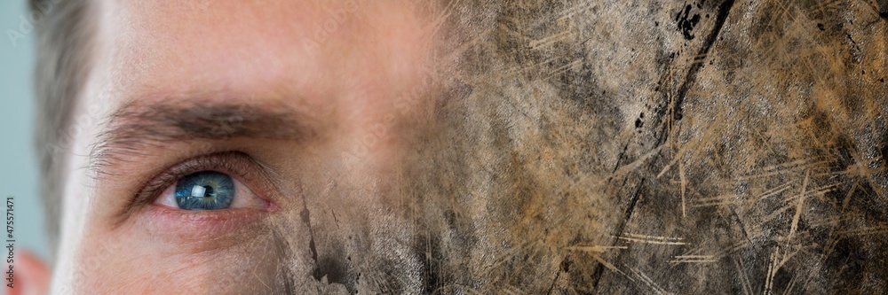 Composite image of close up of a male eye and grunge effect textured background Composite image of close up of a male eye and grunge effect textured background
