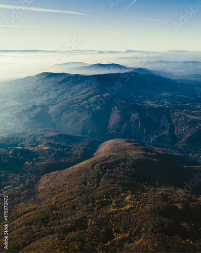 Mountain view with mist over them. Stunning view with blue sky, bright shining sun and white clouds. Bulgarian nature. High quality photo