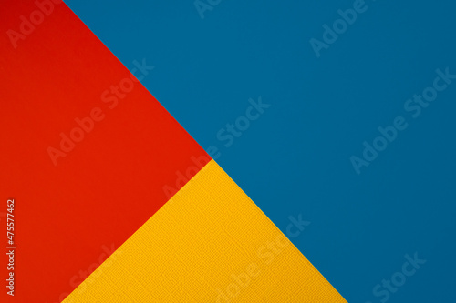 Bright abstract geometric paper background. Red  blue and orange yellow trendy colors. The backdrop for an invitation card  greeting card or web design. Creative copy space  flat lay
