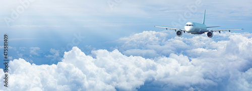 Fotografia Jet plane in a blue cloudy sky.