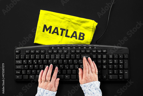 Matlab programming language. Rag width word matlab and hands on pc keyboard. photo