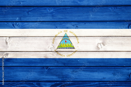 Flag of Nicaragua on wooden surface 