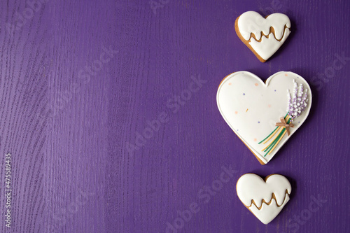 Three gingerbread hearts on wooden background