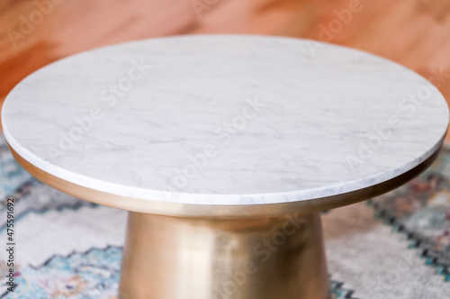 Modern style coffee table with brass metal base, marble top and wooden background. Round coffee table. Modern - Image