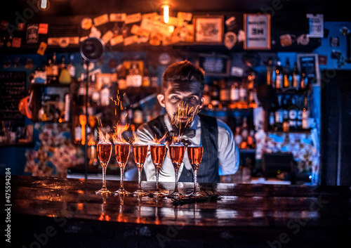 Canvas Charming bartender decorates colorful concoction