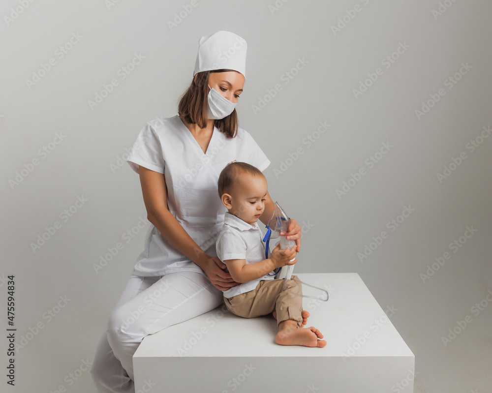 The doctor makes an inhalation procedure for a little boy. high quality  studio photo. children's medicine Stock-Foto | Adobe Stock