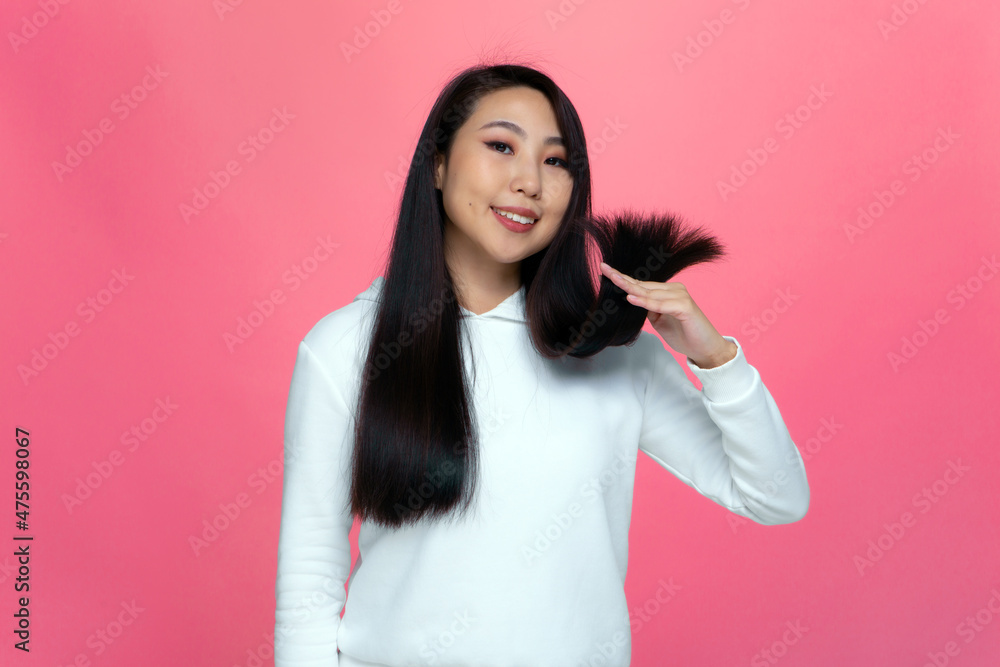 Happy asian young girl satisfied with long strong hairs show healthy hairs tips. Haircare beauty products advertising Happy asian young girl satisfied with long strong hairs show healthy hairs tips. Haircare beauty products advertising