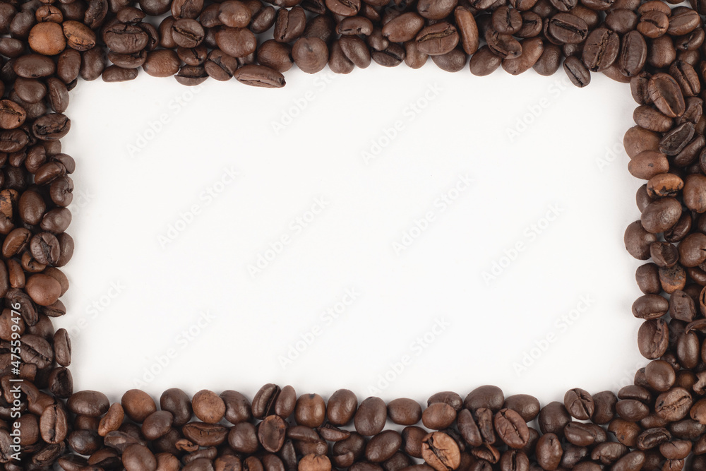 Frame made of roasted coffee beans on white background. Top view, close up, place for text. Frame made of roasted coffee beans on white background. Top view, close up, place for text.