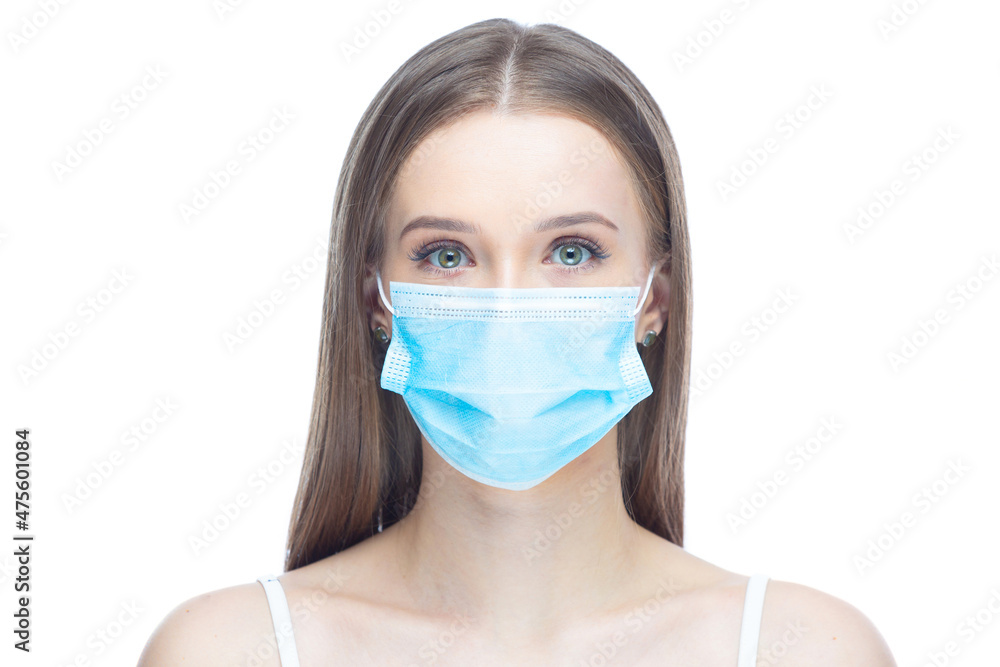 Closeup portrait of a young woman wearing a face mask under stress from coronavirus disease, looking at camera, isolated on white background. Flu epidemic, dust allergy, protection against virus Closeup portrait of a young woman wearing a face mask under stress from coronavirus disease, looking at camera, isolated on white background. Flu epidemic, dust allergy, protection against virus