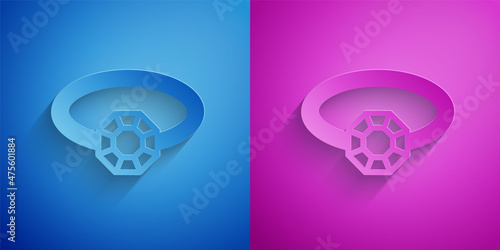 Paper cut Diamond engagement ring icon isolated on blue and purple background. Paper art style. Vector