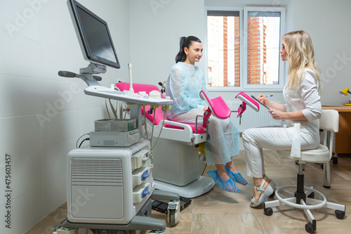 Photo of a gynecologist doctor and a patient on a gynecological chair. Preventive reception, preparation for medical examination, pregnancy management, health care gynecology contol photo
